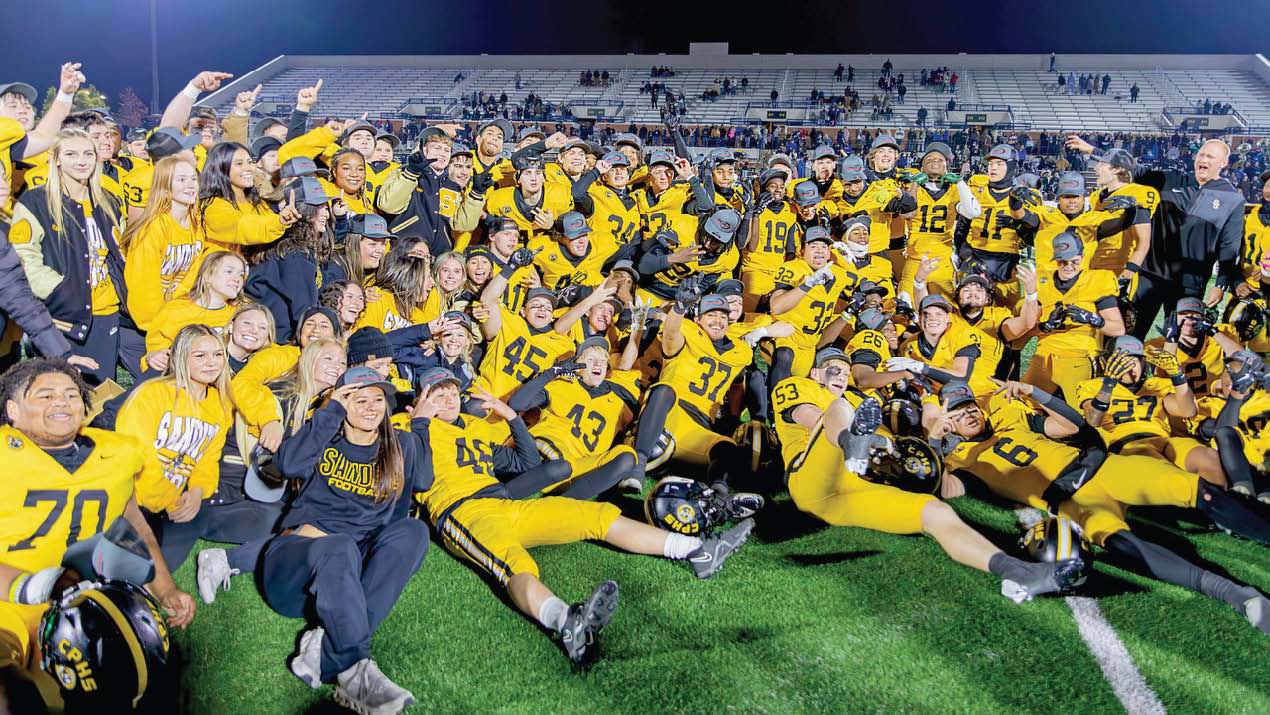 Sandites, coaches, and trainers celebrate during media pictures after winning the Class 6A-II state title. Photo by John Burns