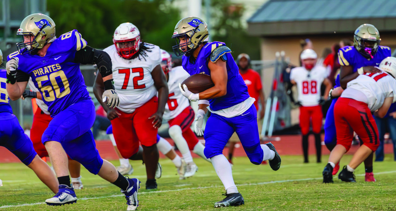Cooper Boyer blocks for Brayden Rodriquez as he gets outside for a gain. Photos by John Burns
