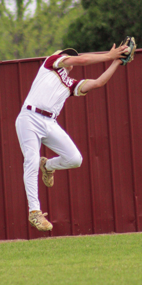 Sophomore Tripp Gaches makes a leaping catch in left field. Photo by Erin McEntire.