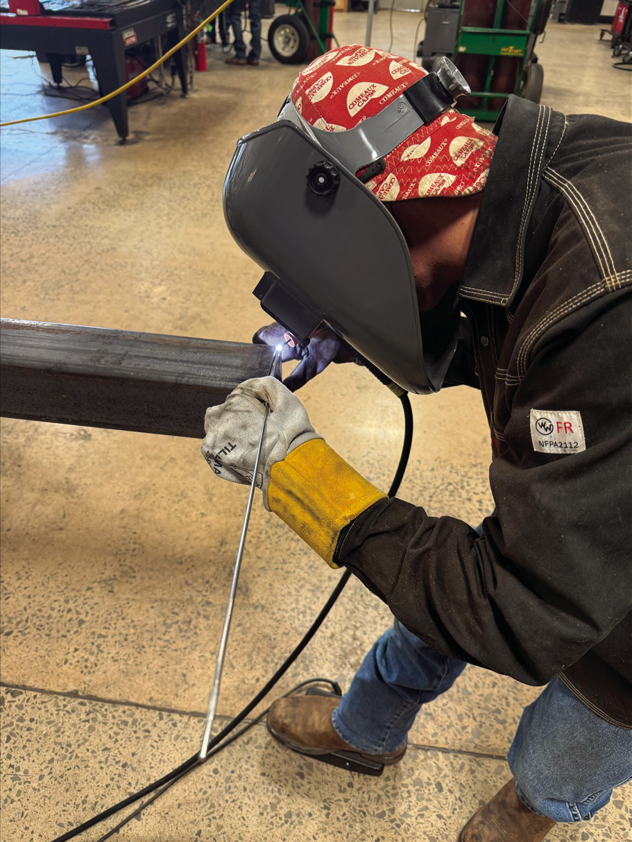 Yale local Cayden Lewis welds one of the light poles in the Central Tech welding shop for the community action project.