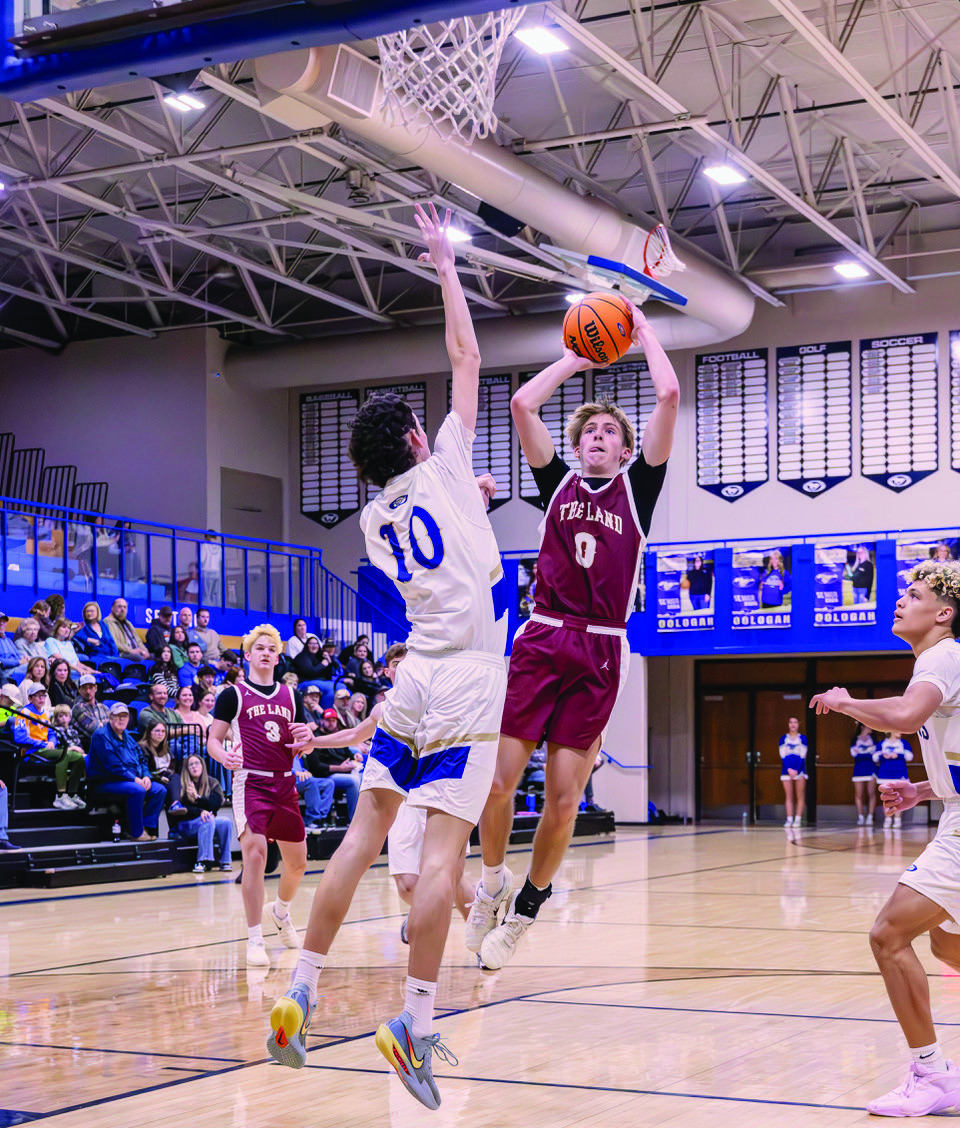 Trey Southward puts up a jumper against an Oologah defender in the opening round of the Oologah tournament. The Tigers took second place and Southward was selected as All Tournament Team. Photo by John Burns