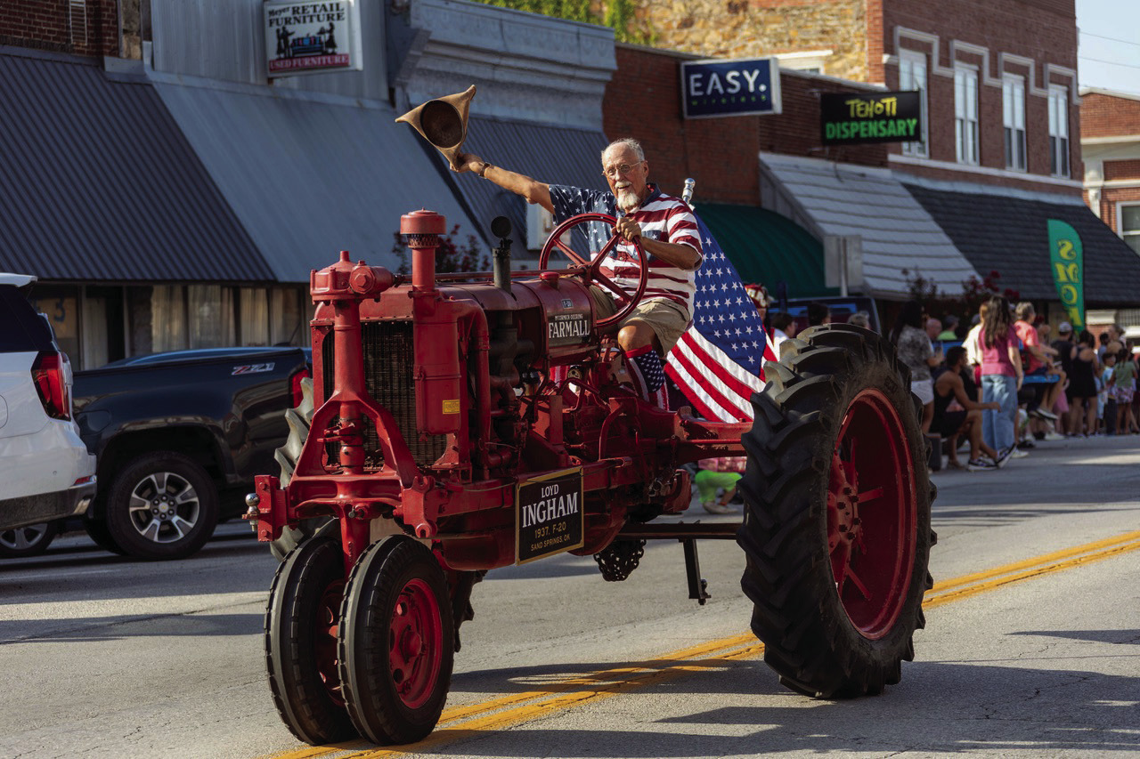 Lloyd Ingham of Sand Springs drives his antique tractor down main street during the Cleveland Pioneer Days Parade. Photo by John Burns.