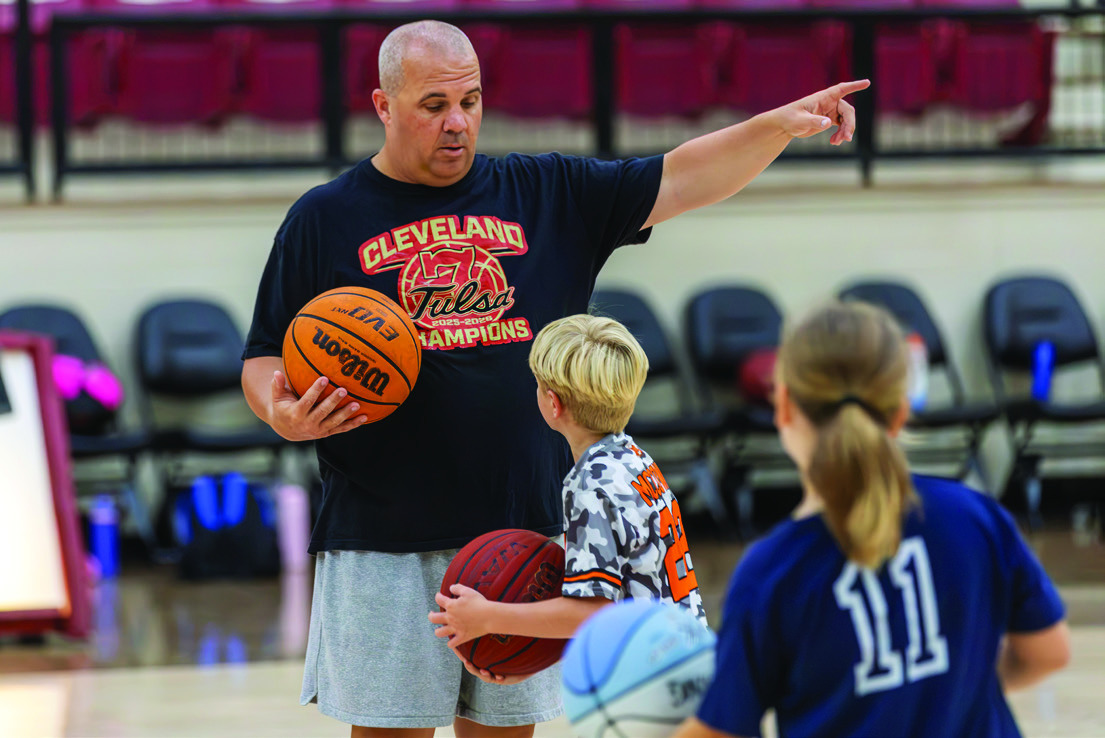 Tiger head coach Daniel Brimmer coaches a young camper. Photo by John Burns.
