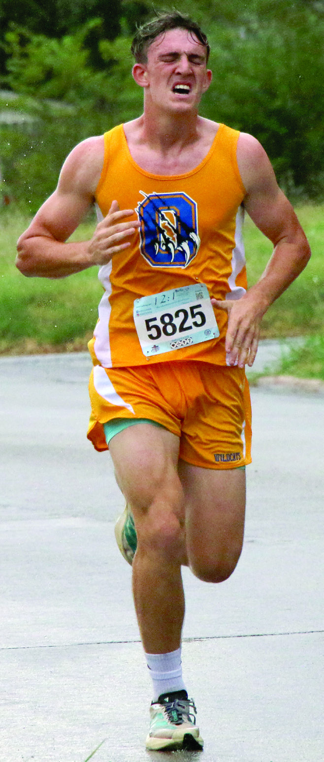 Olive Wildcat River Stonecipher runs in the Grappler’s Gallop during the Cushing Festival in the Park Saturday, Sept. 26. Photo by Allie Prater.