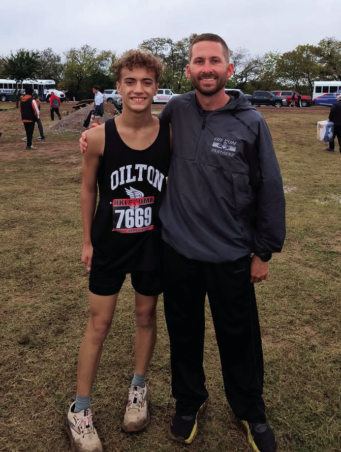 OHS junior Nate Smith stands with coach Jordan Rouintree after Smith placed 58th in the Class 1A boys’ state meet with a time of 19:19.1 and a pace of 6:12.7.