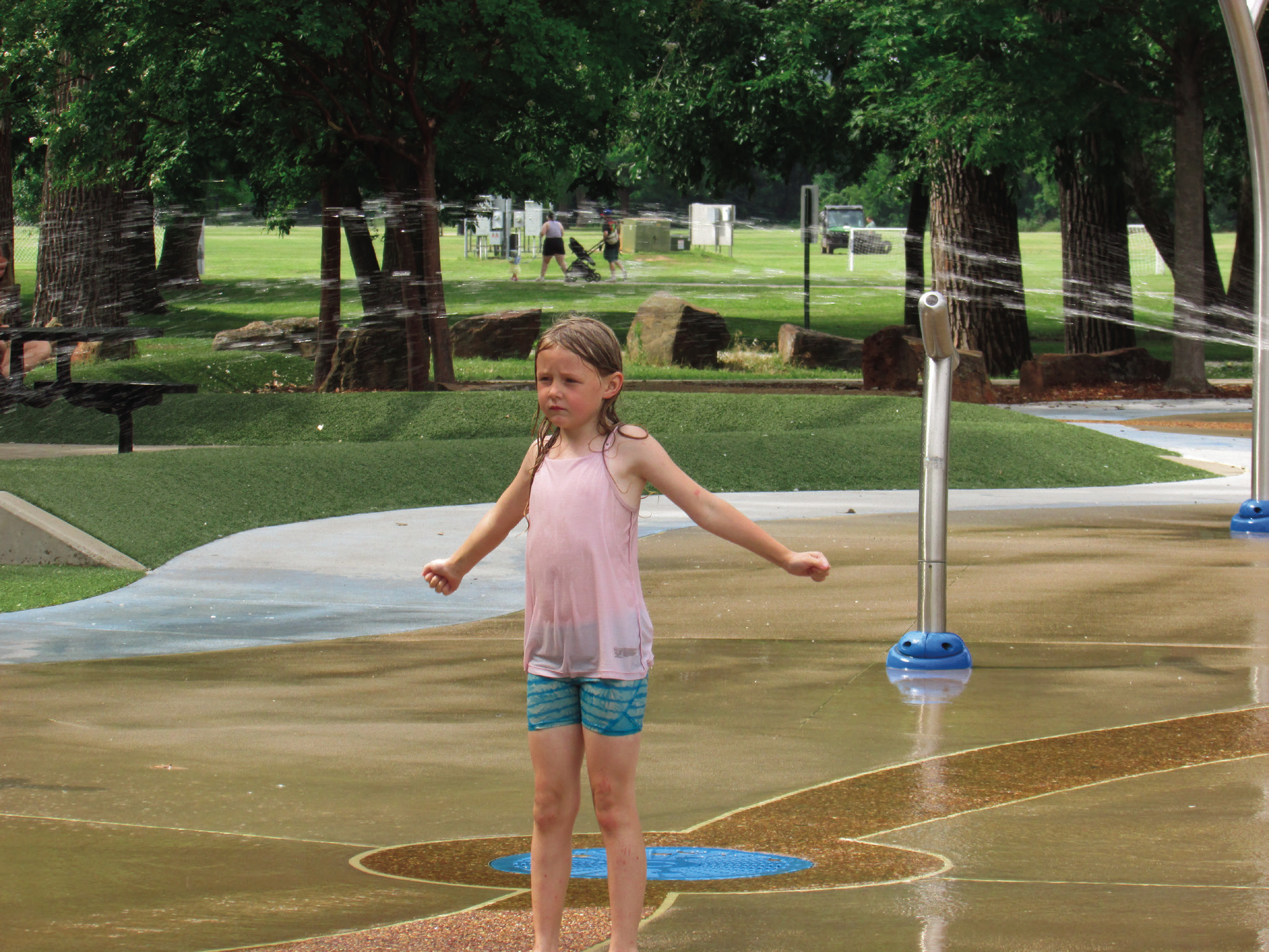 Arya Linquist anxiously awaits a bucket dump at the Super Splash Park located in Case Community Park while she was there with family and friends last week. Photos by DeAnna Maddox