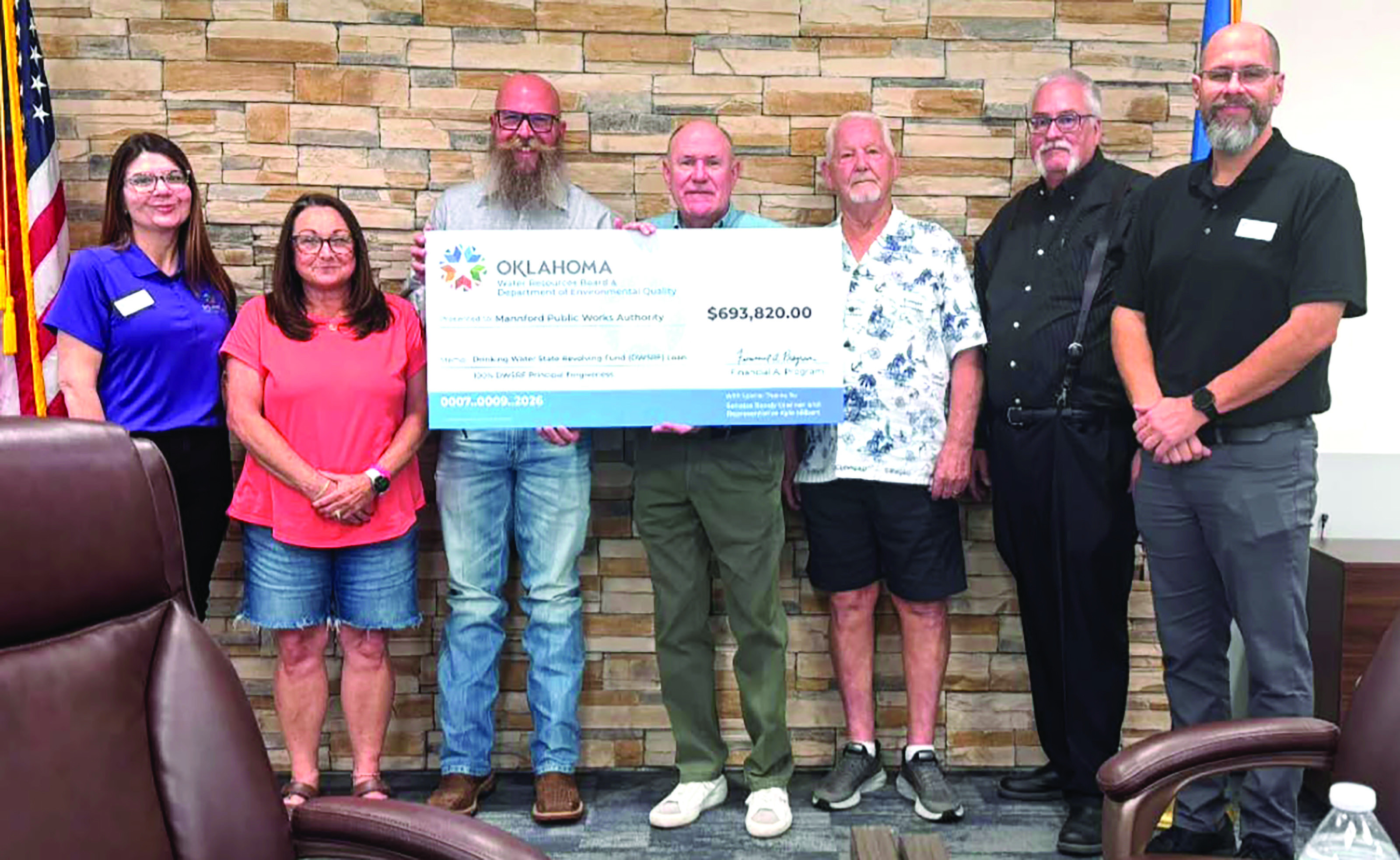 Mannford officials display a ceremonial check for $693,820 from the Oklahoma Water Resources Board to help fund the town’s Advanced Metering Infrastructure project. The loan includes 100 percent principal forgiveness and is expected to save the town an estimated $1.3 million compared with traditional financing.
