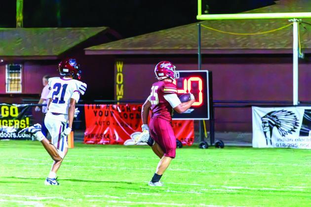 Cleveland’s Carson Taylor scampers into the end zone after a 60-yard breakaway run. Photo by John Burns