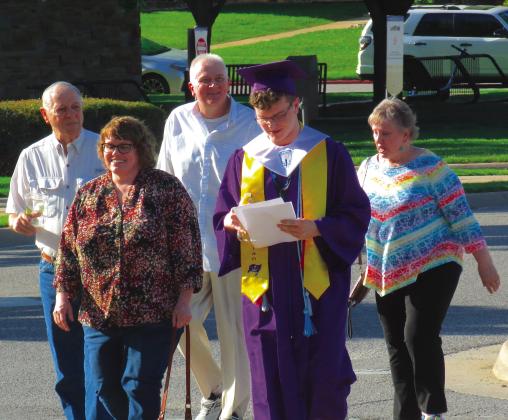 MHS Class of 2024 President J.D. Grant prepares for the upcoming ceremony while walking with his family, Friday, May 10. Photo by DeAnna Maddox