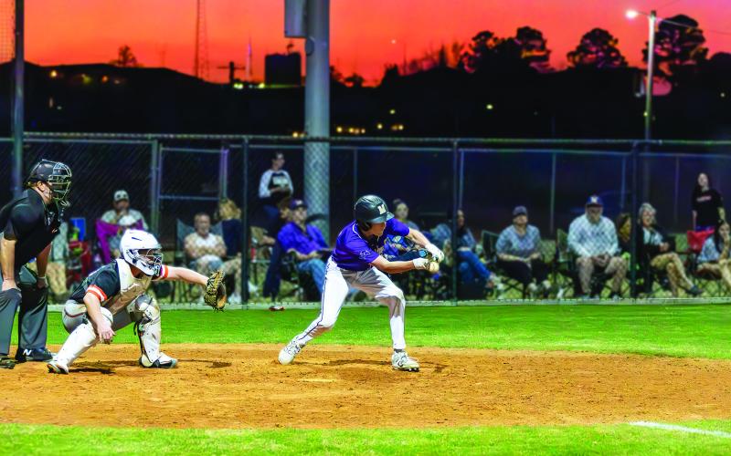 Mannford’s Luke Barnes lays down a text-book bunt against Sperry. See story inside. Photo by John Burns