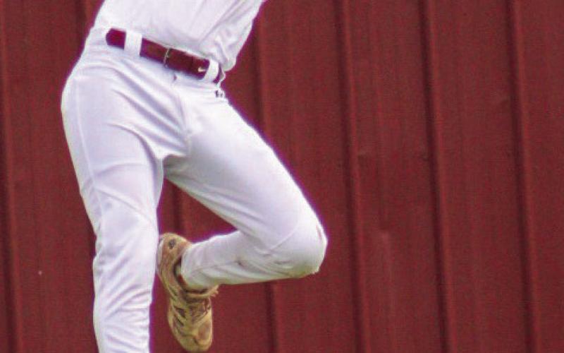 Sophomore Tripp Gaches makes a leaping catch in left field. Photo by Erin McEntire.