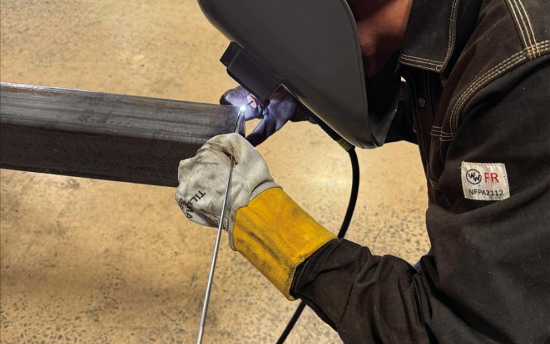 Yale local Cayden Lewis welds one of the light poles in the Central Tech welding shop for the community action project.