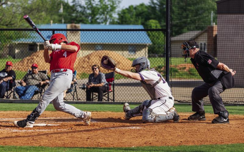 Pirate Catcher Lyndon Hamilton gloves the pitch as Ft. Gibson’s Tucker Forrest takes a swipe at it. Photo by John Burns