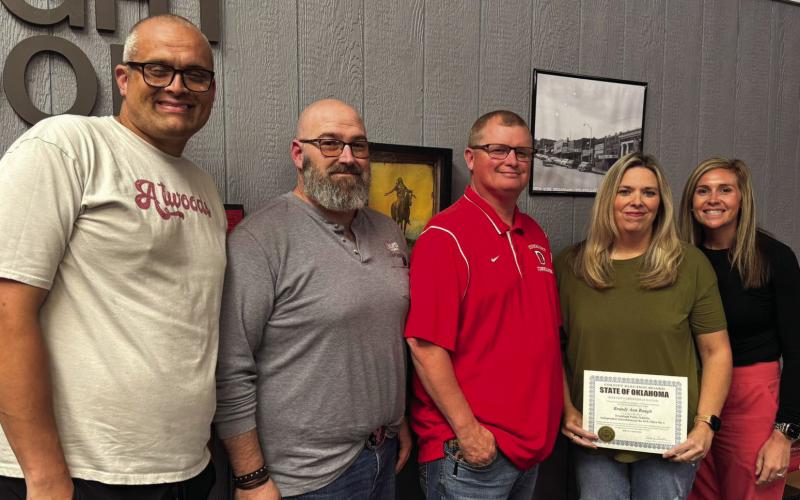 Newest board member Brandy Baugh holds the official certification surrounded by the other members — Billy Brimmer, Gary Todd, Lake Barber, and Emily Snow — following the swear in ceremony.