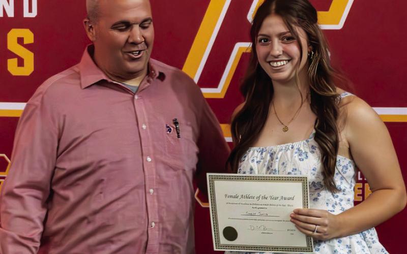 Daniel Brimmer presents the Female Athlete of the Year award to Gabby Smith.