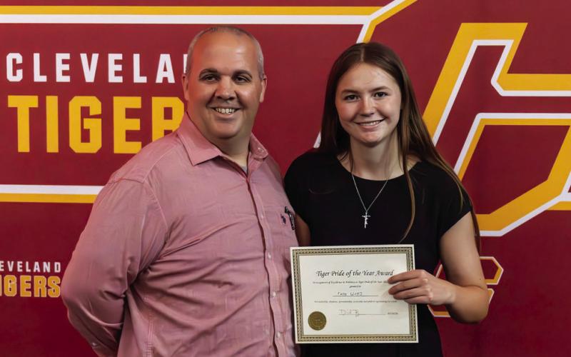Daniel Brimmer presents the Tiger Pride Award to Faith Watts.