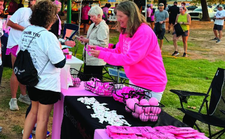 Pictured at the Enid breast cancer awareness event, Shyla Eggers promotes Stillwater Medical Center. After years of helping share patient stories, Eggers recently found herself navigating her own health journey with sleep apnea.